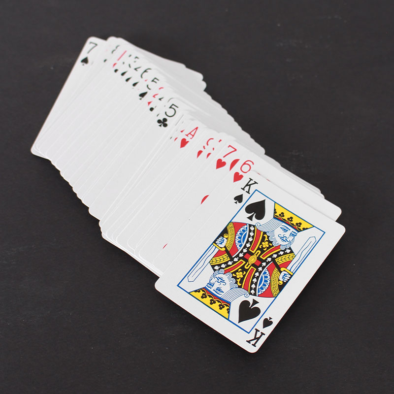 A photo of playing cards splayed out on a black background