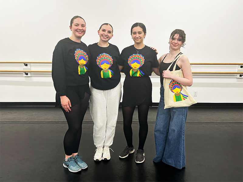 A photo of four women wearing the festival's merchandise